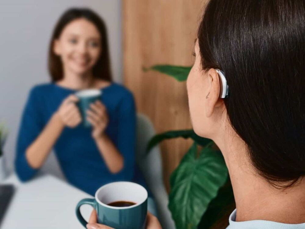 Woman wearing a receiver-in-canal hearing aid, one of six hearing aid styles fitted at AUDIO-LOGIC, PC in Columbus, NE