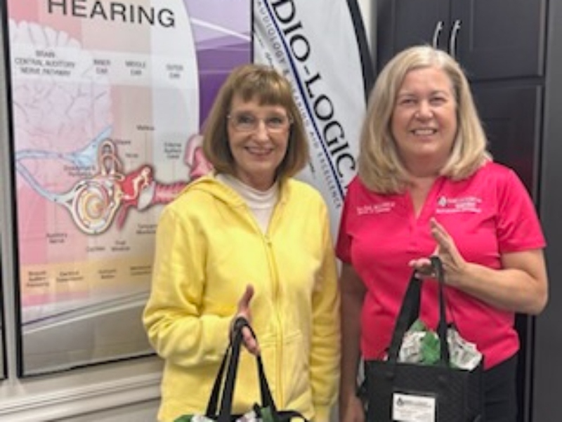 Dr. Nora Fuchs with a smiling patient inside AUDIO-LOGIC, PC, an independent hearing clinic in Columbus, NE